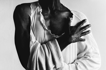 black man wearing a torn, distressed, white shirt - 215540616