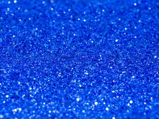 Blue sparkling glitter bokeh background.