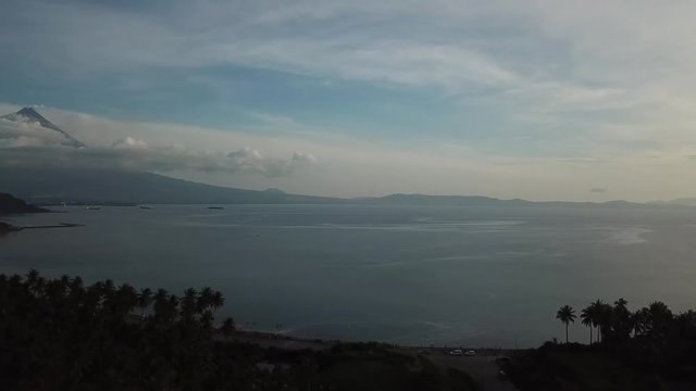 AERIAL SHOT: Puro and Lamba, Legazpi City, Philippines. Views of cocount trees, Mayon Volcano and the sea
