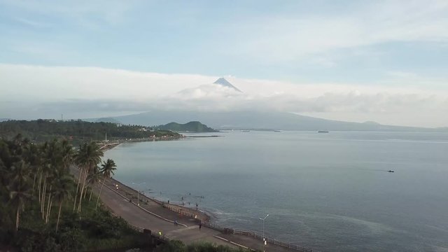 AERIAL SHOT: Puro and Lamba, Legazpi City, Philippines. Views of cocount trees, Mayon Volcano and the sea
