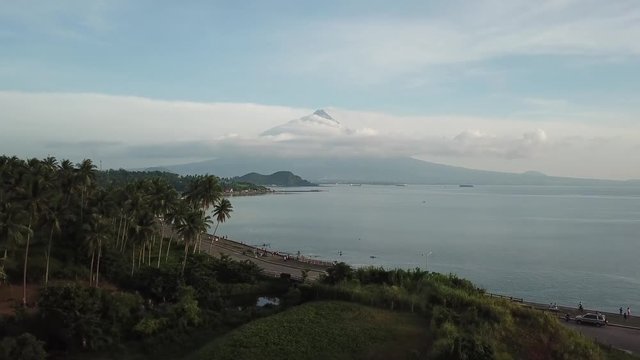 AERIAL SHOT: Puro and Lamba, Legazpi City, Philippines. Views of cocount trees, Mayon Volcano and the sea