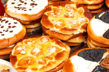Fresh pastries for sale in a bakery. Sales of different types of cakes in the farmers' markets. Sweet pastry at the market. Apricot, poppy, marmalade and fruit cakes.