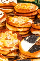 Fresh pastries for sale in a bakery. Sales of different types of cakes in the farmers' markets. Sweet pastry at the market. Apricot, poppy, marmalade and fruit cakes.