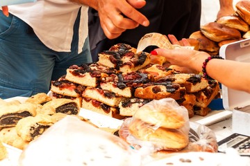 Fresh pastries for sale in a bakery. Sales of different types of cakes in the farmers' markets. Sweet pastry at the market. Apricot, poppy, marmalade and fruit cakes.