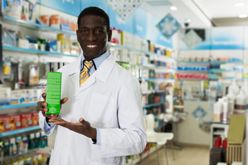 African American pharmacist offering medication