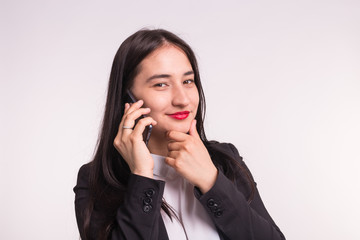 Fototapeta na wymiar Beautiful asian girl in formal clothes with phone on white background