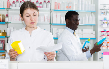 female pharmacist dispensing prescription medicines