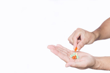 Pills in hand on white background, concept about healthcare and medical