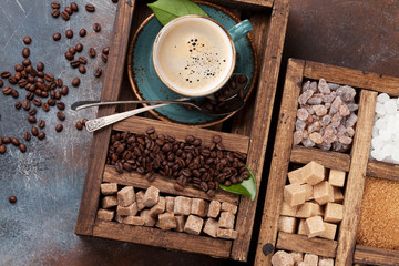 Coffee cup, roasted beans and brown sugar