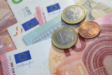 Mix of euro banknotes and coins altogether