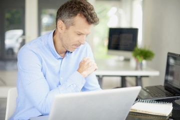 Businessman working on laptop at the office