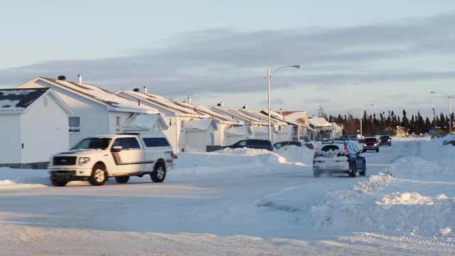 Winter traffic and houses in the Cree town of Chisasibi, northern Quebec, in winter