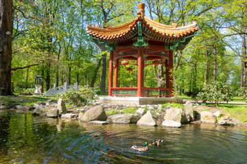 Traditional Chinese temple in forest or Lazienki park in Warsaw, Poland.