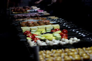 long barbecue meat, fish, vegetables, mushrooms on the grill