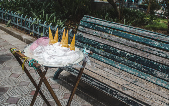 Ecuadorian street food stand by a park bench for traditional guanaba and strawberry flavored Espumilla, a meringue cream similar to ice cream that doesn't melt