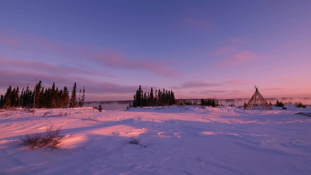 Teepee at dawn by misty northern river in winter, very wide