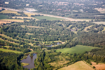 Fototapeta na wymiar Aerial top view of forest, lake, road and city near Kiev, Ukraine