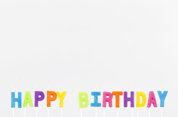 Colorful letter candles, Happy Birthday candles on grey background with copy space. Happy Birthday concept or background