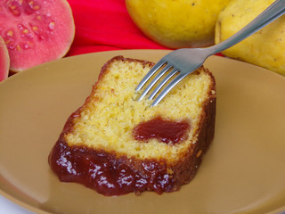 Typical Brazilian sweet dessert corn cake with guava paste. And guavas fruits  composing the scene.
