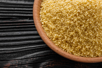 fresh couscous on a wooden rustic background