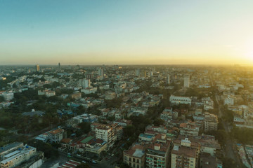 Naklejka na ściany i meble beautiful aerial view of sunrise over a city full of buildings near the beach