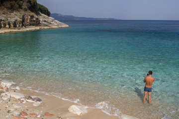 A man is resting on the beach of Albania. Ionian Sea