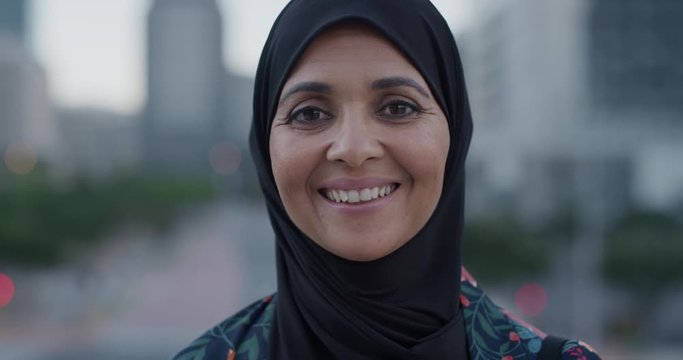 slow motion portrait middle aged muslim woman smiling happy enjoying successful urban lifestyle independent senior female wearing hijab headscarf in city at sunset