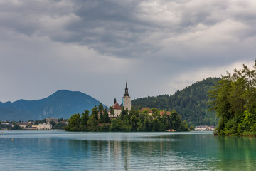 Fototapeta na wymiar Bled lake after the storm with dark clouds. Slovenia touristic place in Europe.
