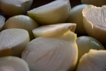 Fototapeta na wymiar white onion cut in half on a wooden plate