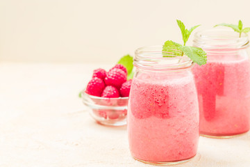 Raspberry smoothie close up photography of fresh summer blended cocktail and ripe pink berries with copy space.