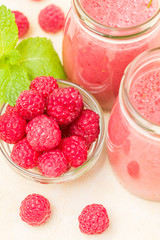 Raspberry smoothie close up macro photography - top view of fresh summer blended cocktail and ripe pink berries.