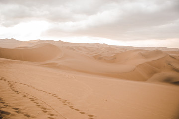 Obraz na płótnie Canvas Footprints in the sand of the desert outside Huacachina in Ica, Peru