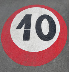 large road sign painted on the asphalt indicating the maximum sp