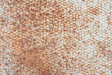 Old, rusty and white, metal plate with diamond shaped no slip grid on it