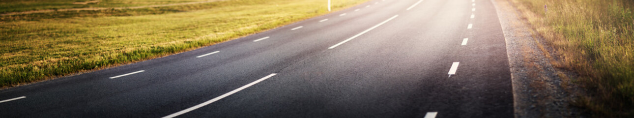 black asphalt road and white dividing lines