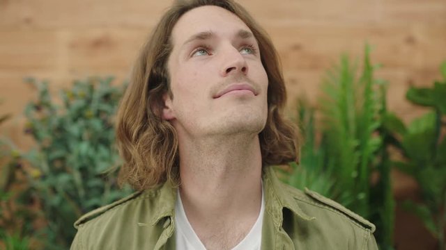 close up portrait of young pensive caucasian man thinking looking up 