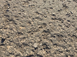 old asphalt road in the rays of the setting sun