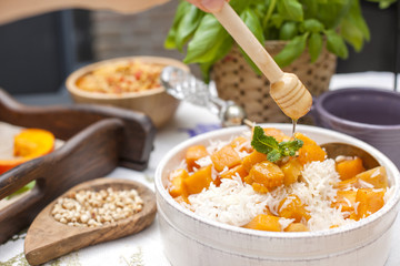 Sweet rice with pumpkin and spices and honey. Autumn lunch for the whole family in the courtyard. Copy space,