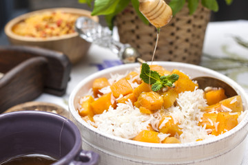 Sweet rice with pumpkin and spices. Autumn lunch for the whole family in the courtyard. Copy space.