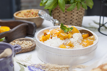Sweet rice with pumpkin and spices. Autumn lunch for the whole family in the courtyard. Copy space,