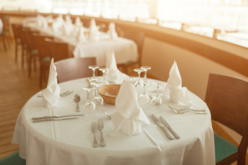 Beautiful table served with glassware and cultery, prepared for festive event. Special occasion celebrted in luxury restaurant or cafe. Table setting concept. Wedding table