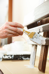 Person renovating wooden hanger