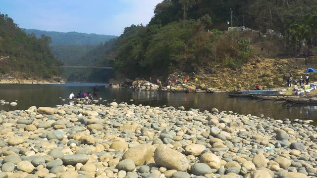 Panning shot across Piyain River in Jaflong, Sylhet. Shot from the river bank.