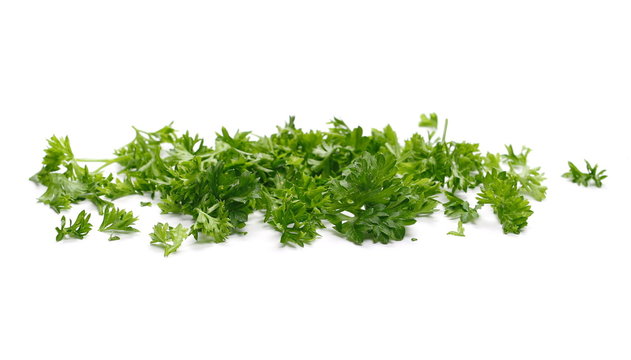 Fresh green chopped parsley leaves isolated on white background