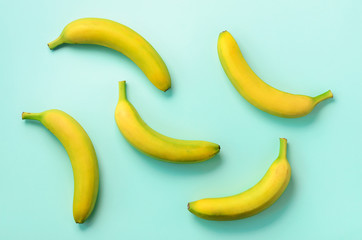Colorful fruit pattern. Bananas over blue background. Top view. Pop art design, creative summer concept. Minimal flat lay style.