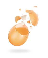 Broken chicken egg hanging in the air on a white background