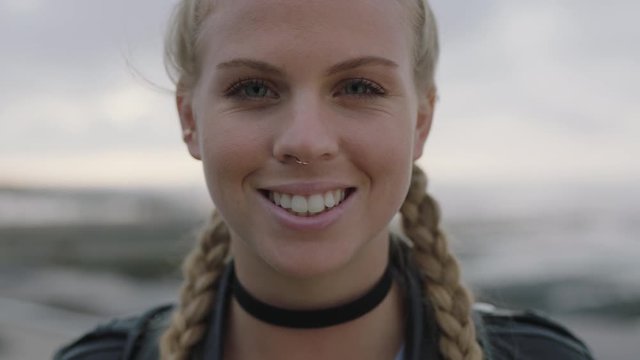 close up portrait of beautiful blonde woman with braided hair smiling cheerful looking to camera 