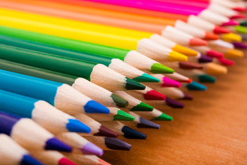 Many colored pencils on a wooden table. Back to school. Creation. Stationery. Art. Education.