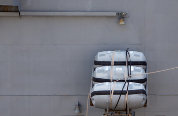 Inflatable life rafts are installed in the working position on board the warship.