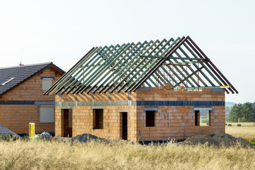 Fototapeta na wymiar Construction of a house made of bricks, roof repair, new building